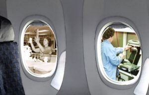 Old photos visible through jet airliner windows