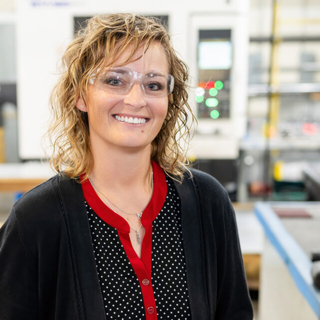 Smiling woman wearing safety glasses