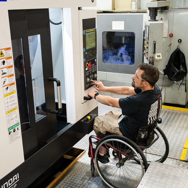 Man operating CNC machine