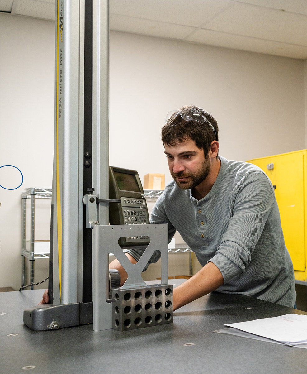 Man using CMM tool for measurement and quality assurance