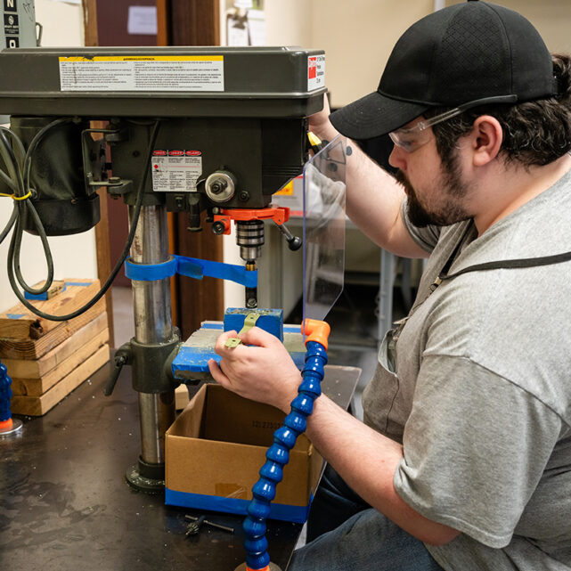 Man operating desktop assembly machine