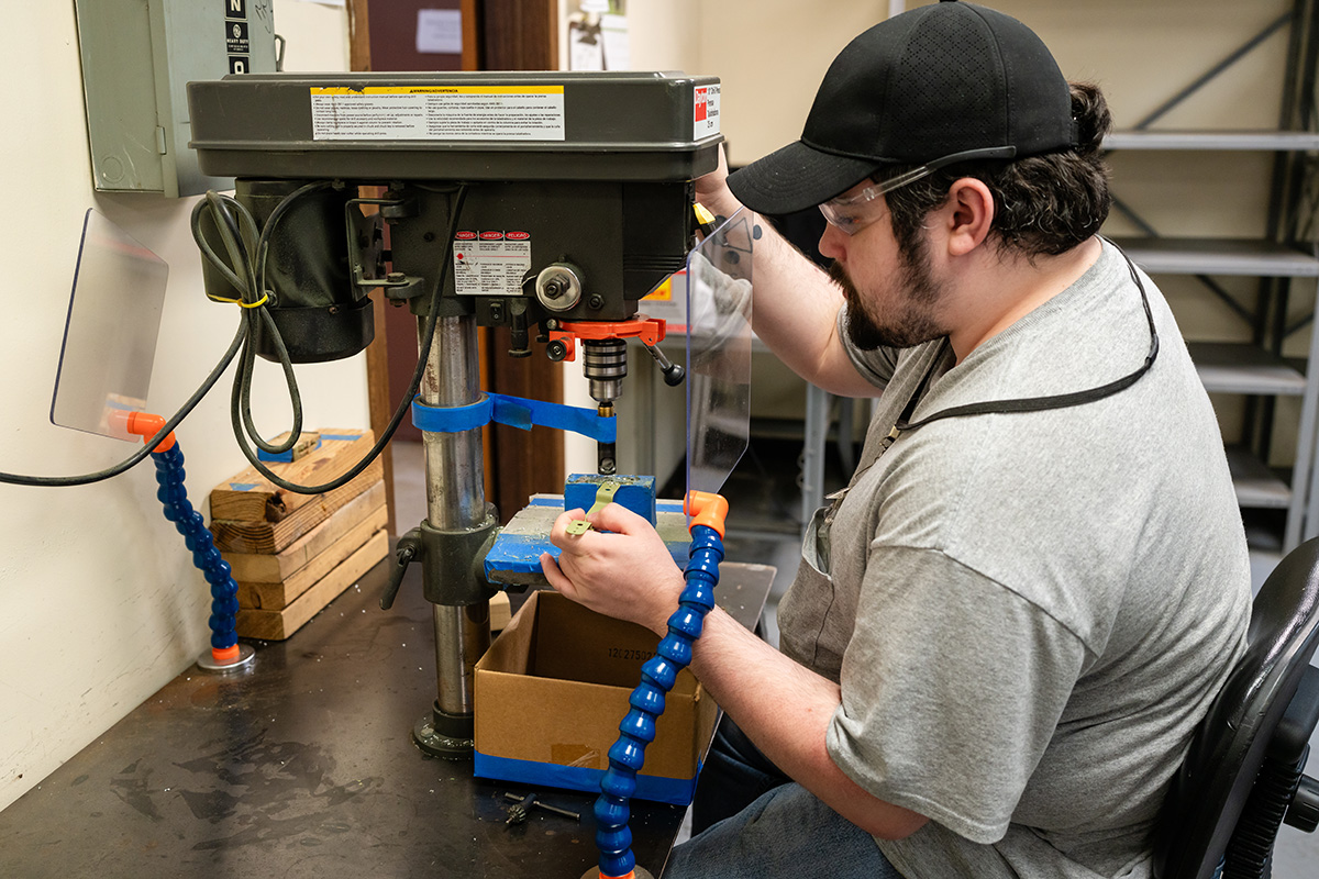 Man operating desktop assembly machine