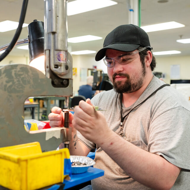 Worker producing parts in Center's Desktop Assembly department