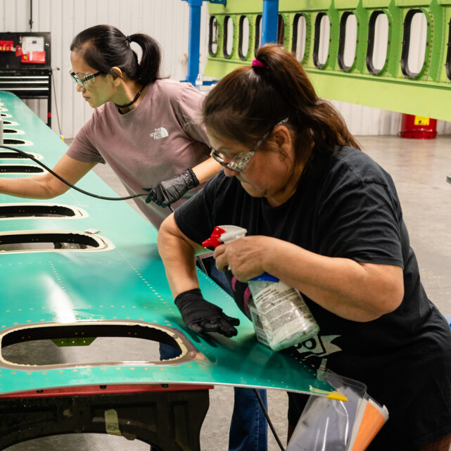 Employees sealing an airline panel